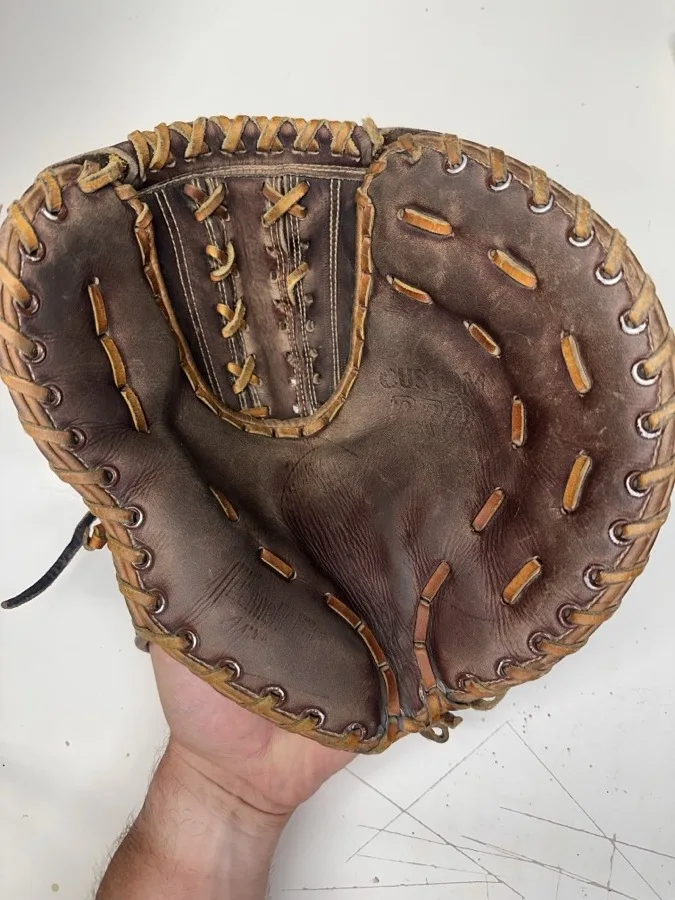 Franklin baseball glove before restoration — worn leather and frayed laces