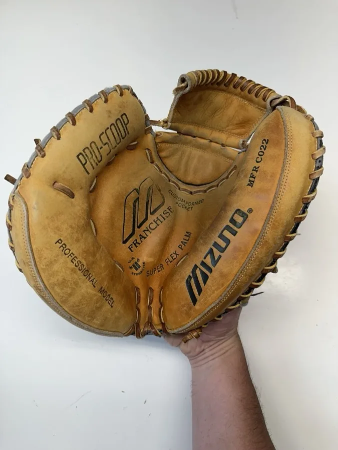 Mizuno baseball glove before restoration — worn leather and frayed laces