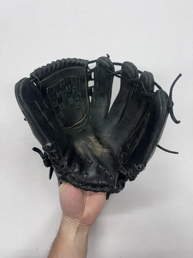 Mizuno baseball glove before restoration — worn leather and frayed laces