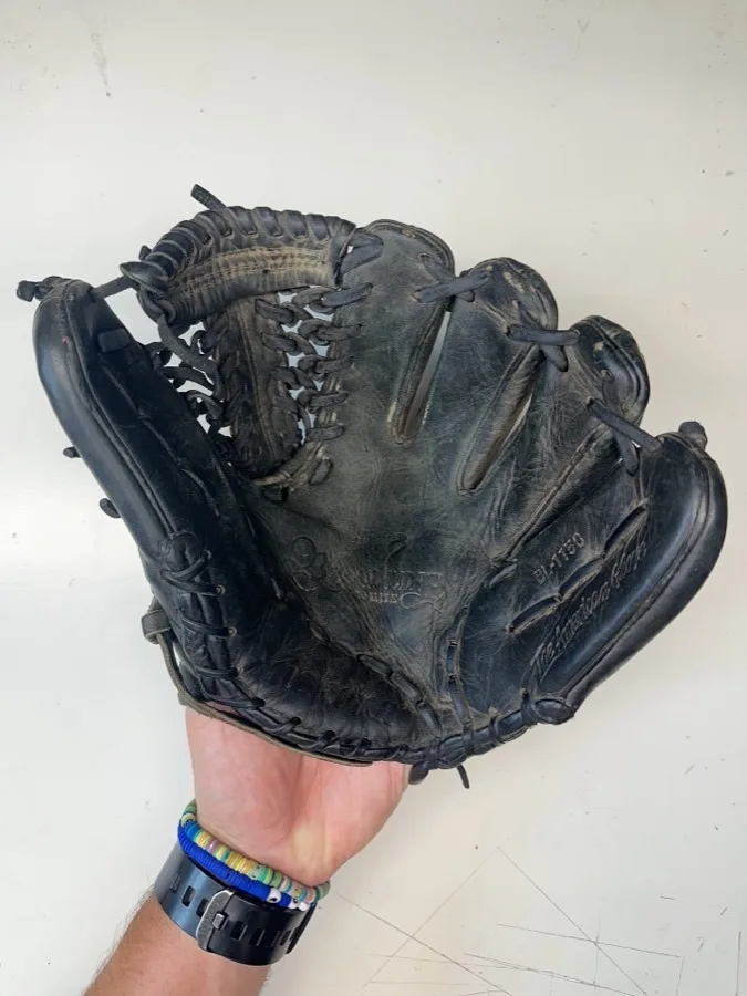 Nokona baseball glove before restoration — worn leather and frayed laces