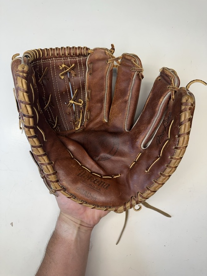 Nokona baseball glove before restoration — worn leather and frayed laces