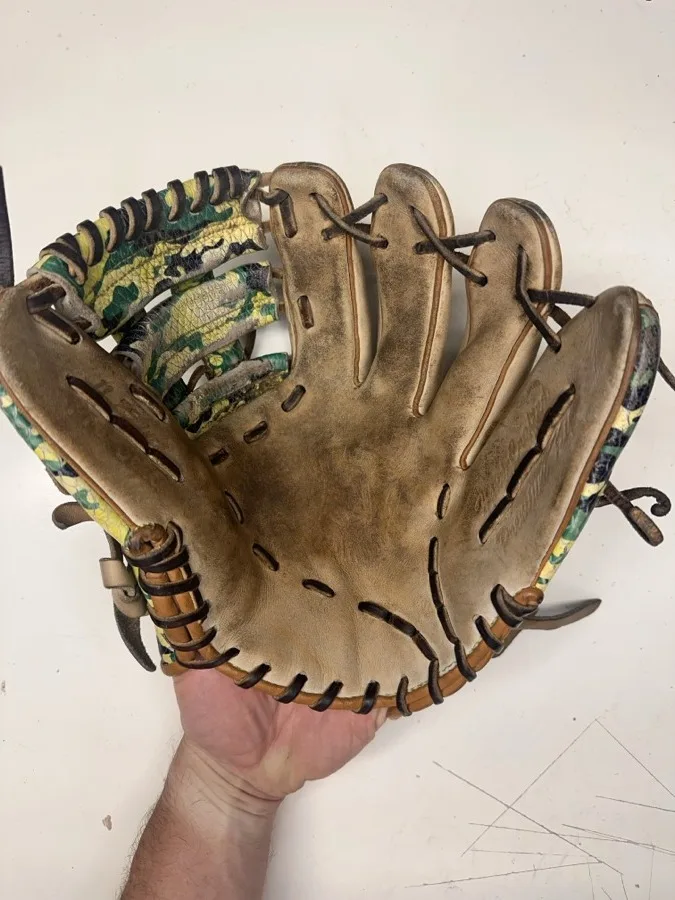 Patriot baseball glove before restoration — worn leather and frayed laces