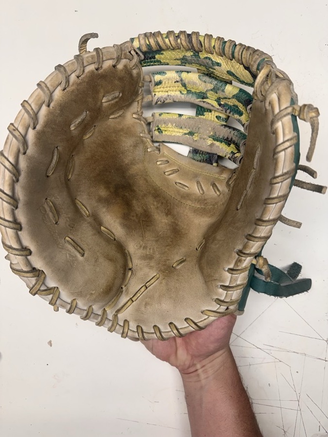 Patriot baseball glove before restoration — worn leather and frayed laces