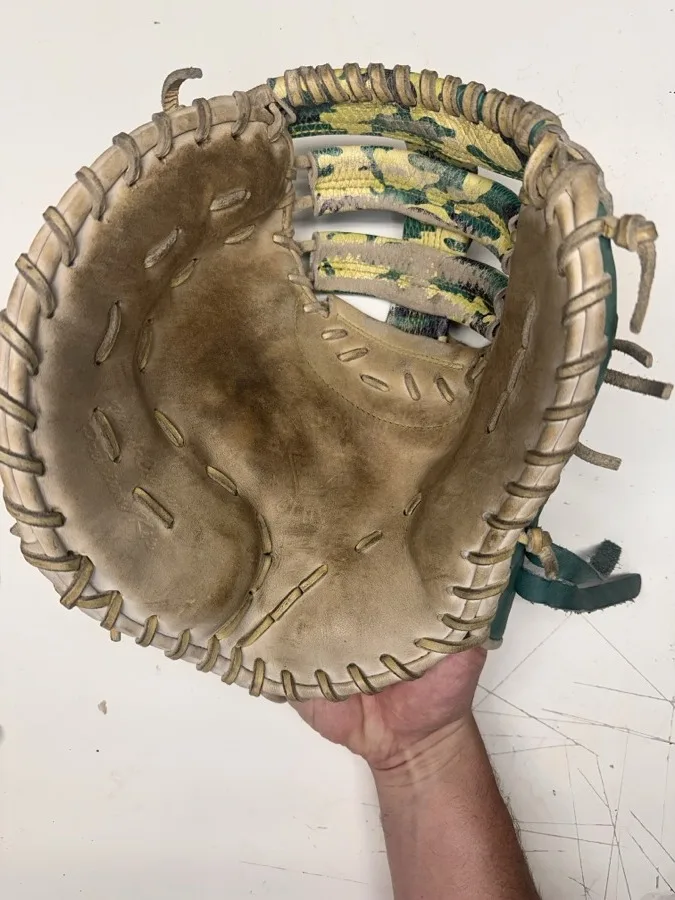 Patriot baseball glove before restoration — worn leather and frayed laces