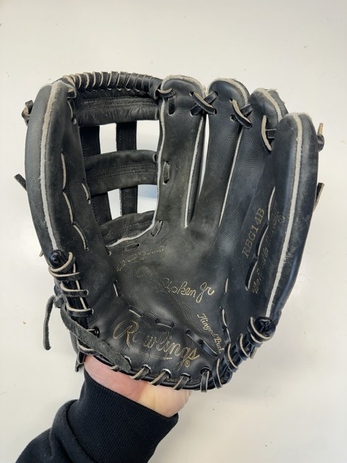 Rawlings baseball glove before restoration — worn leather and frayed laces