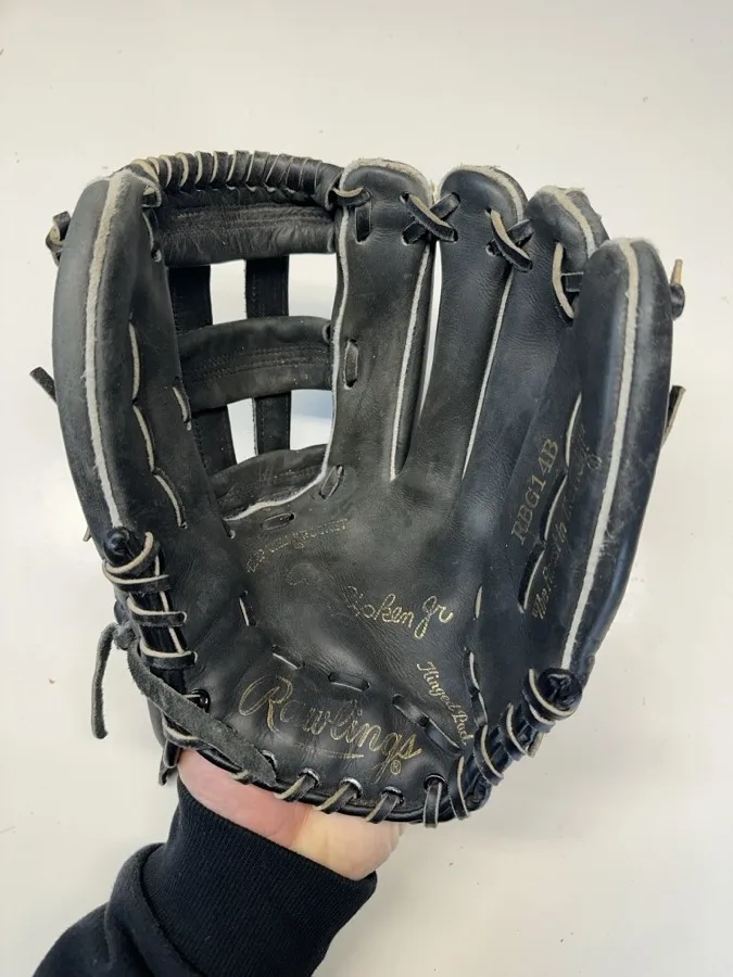 Rawlings baseball glove before restoration — worn leather and frayed laces