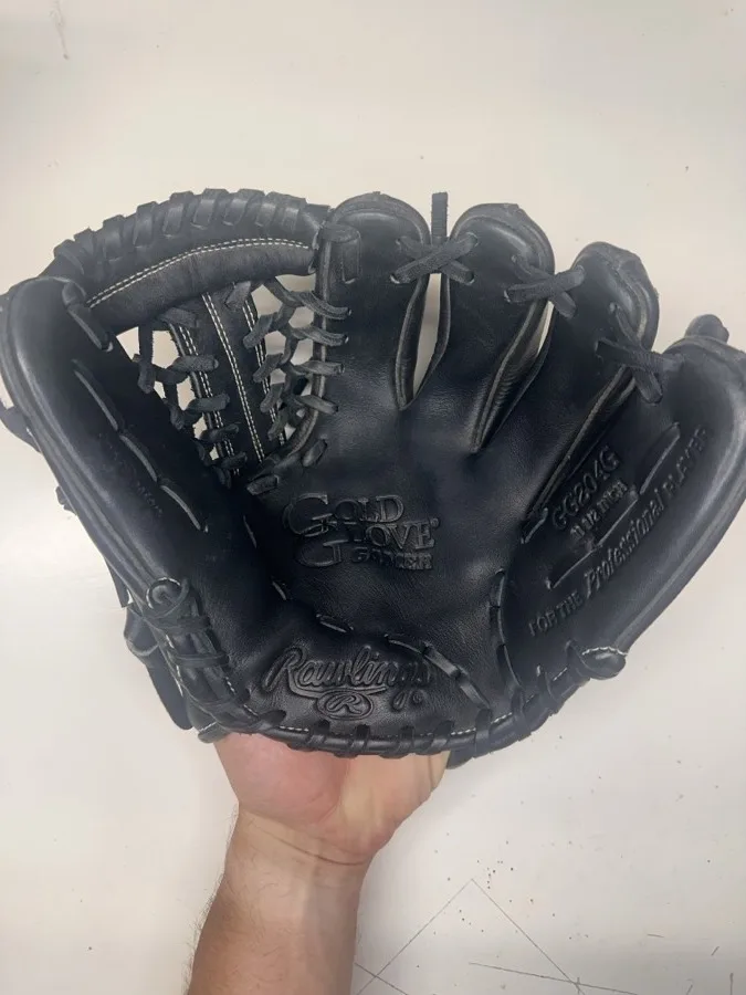 Rawlings baseball glove before restoration — worn leather and frayed laces