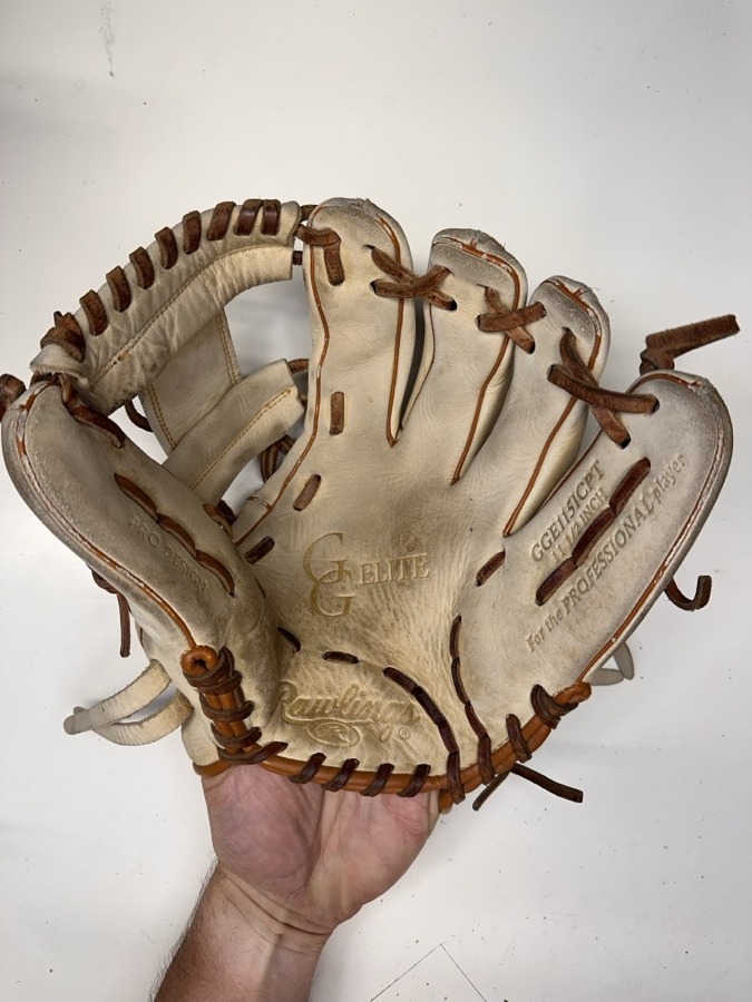 Rawlings baseball glove before restoration — worn leather and frayed laces