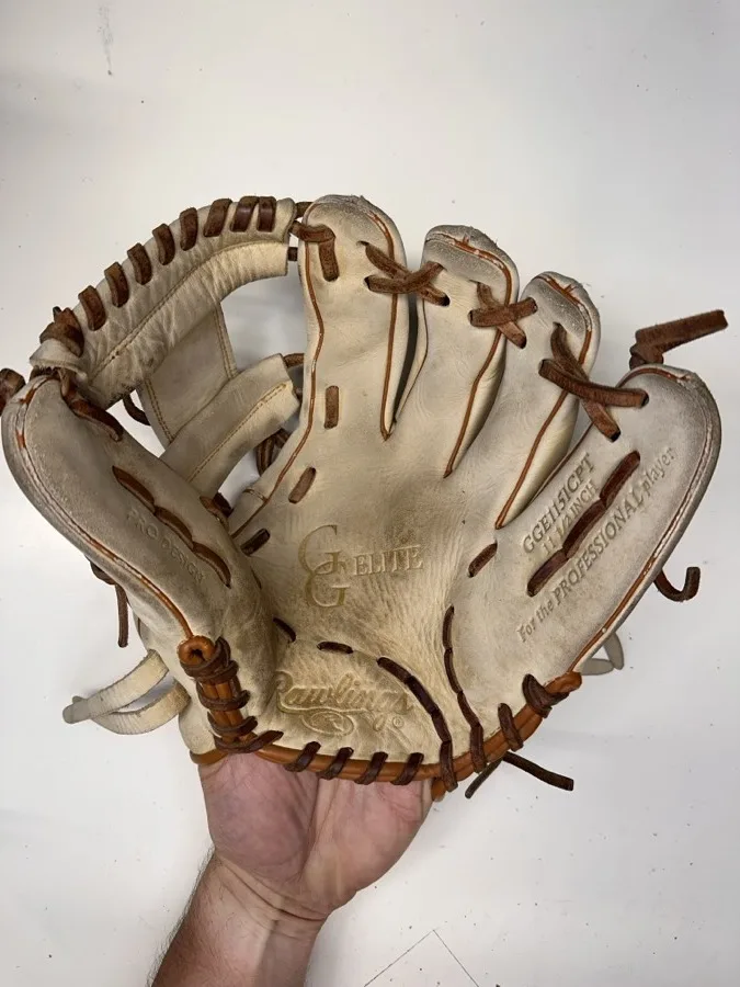 Rawlings baseball glove before restoration — worn leather and frayed laces