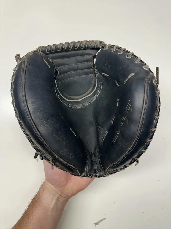 Rawlings baseball glove before restoration — worn leather and frayed laces