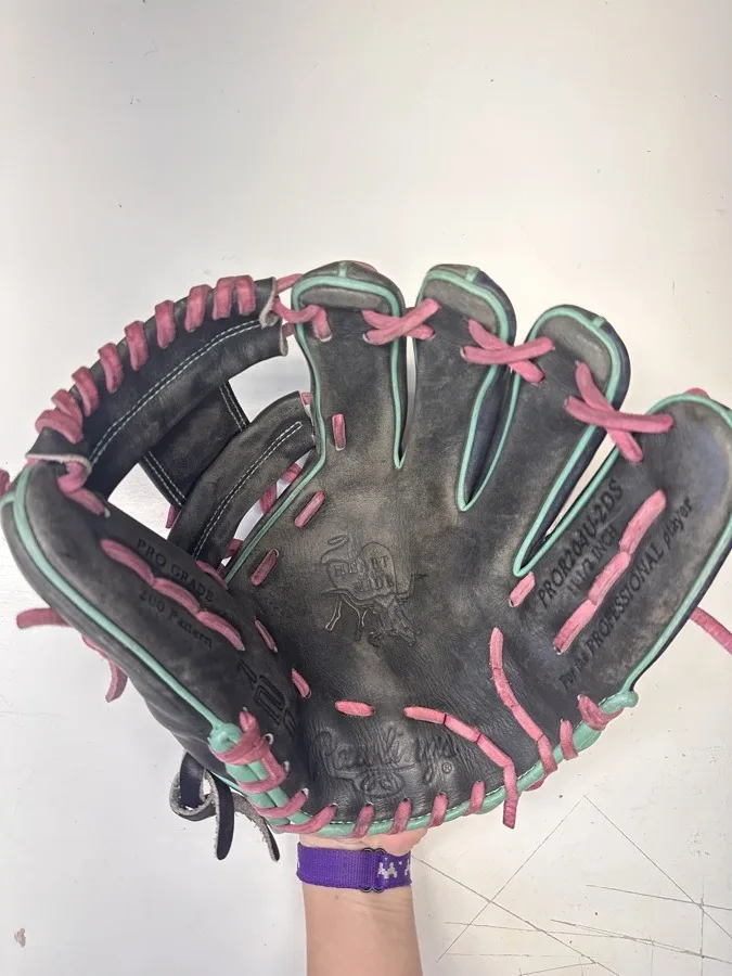 Rawlings baseball glove before restoration — worn leather and frayed laces