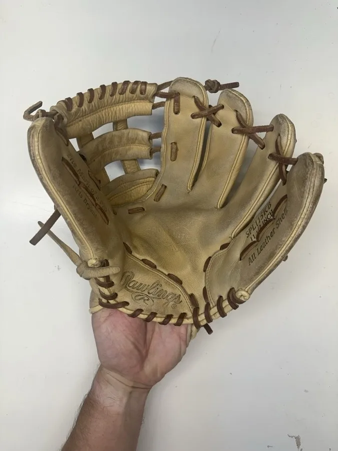 Rawlings baseball glove before restoration — worn leather and frayed laces