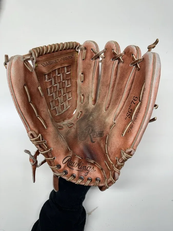 Rawlings baseball glove before restoration — worn leather and frayed laces