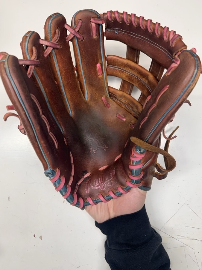 Rawlings baseball glove before restoration — worn leather and frayed laces