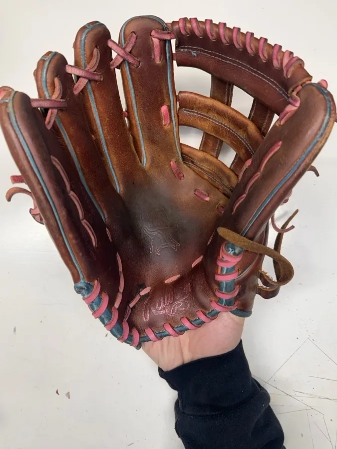 Rawlings baseball glove before restoration — worn leather and frayed laces