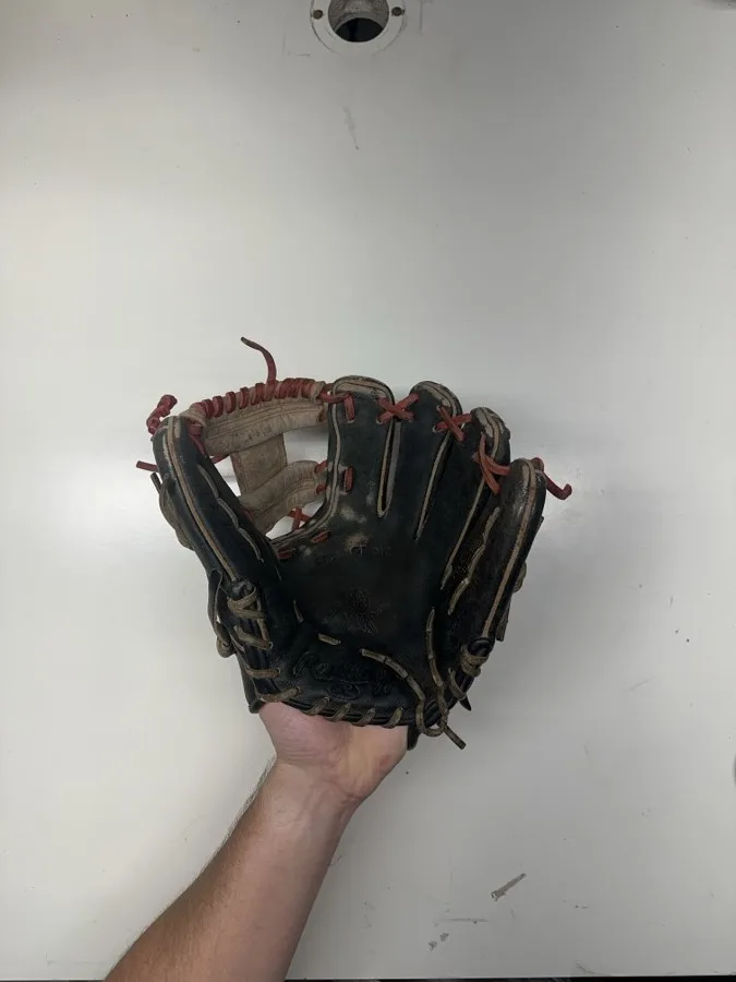 Rawlings baseball glove before restoration — worn leather and frayed laces