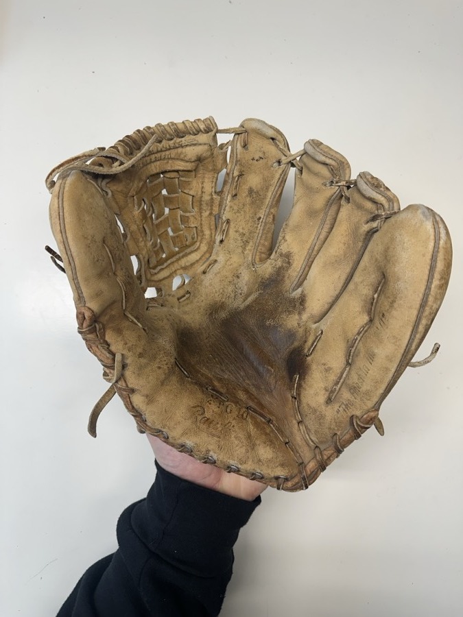 Rawlings baseball glove before restoration — worn leather and frayed laces