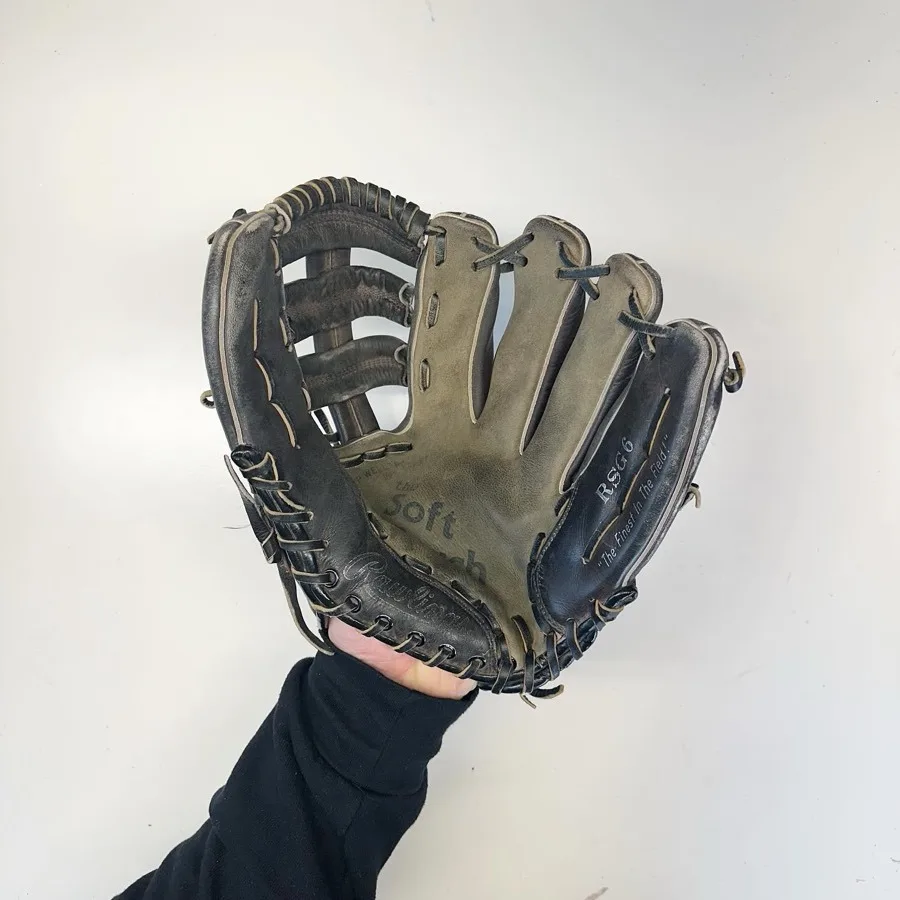 Rawlings baseball glove before restoration — worn leather and frayed laces