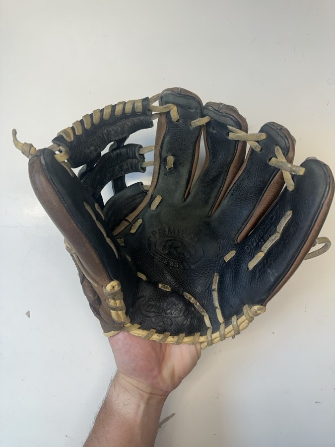 Rawlings baseball glove before restoration — worn leather and frayed laces