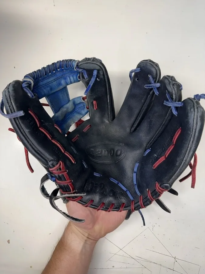 Wilson baseball glove before restoration — worn leather and frayed laces