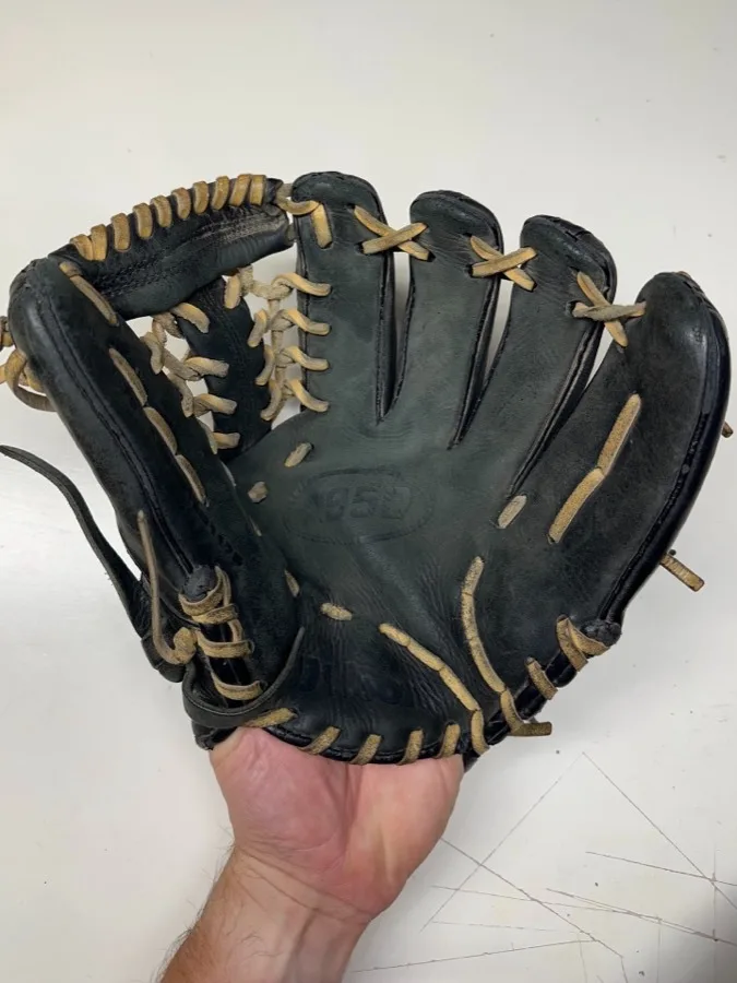 Wilson baseball glove before restoration — worn leather and frayed laces
