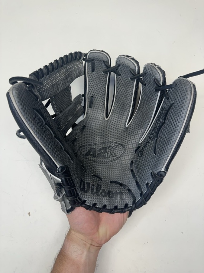 Wilson A2K baseball glove before restoration — worn leather and frayed laces